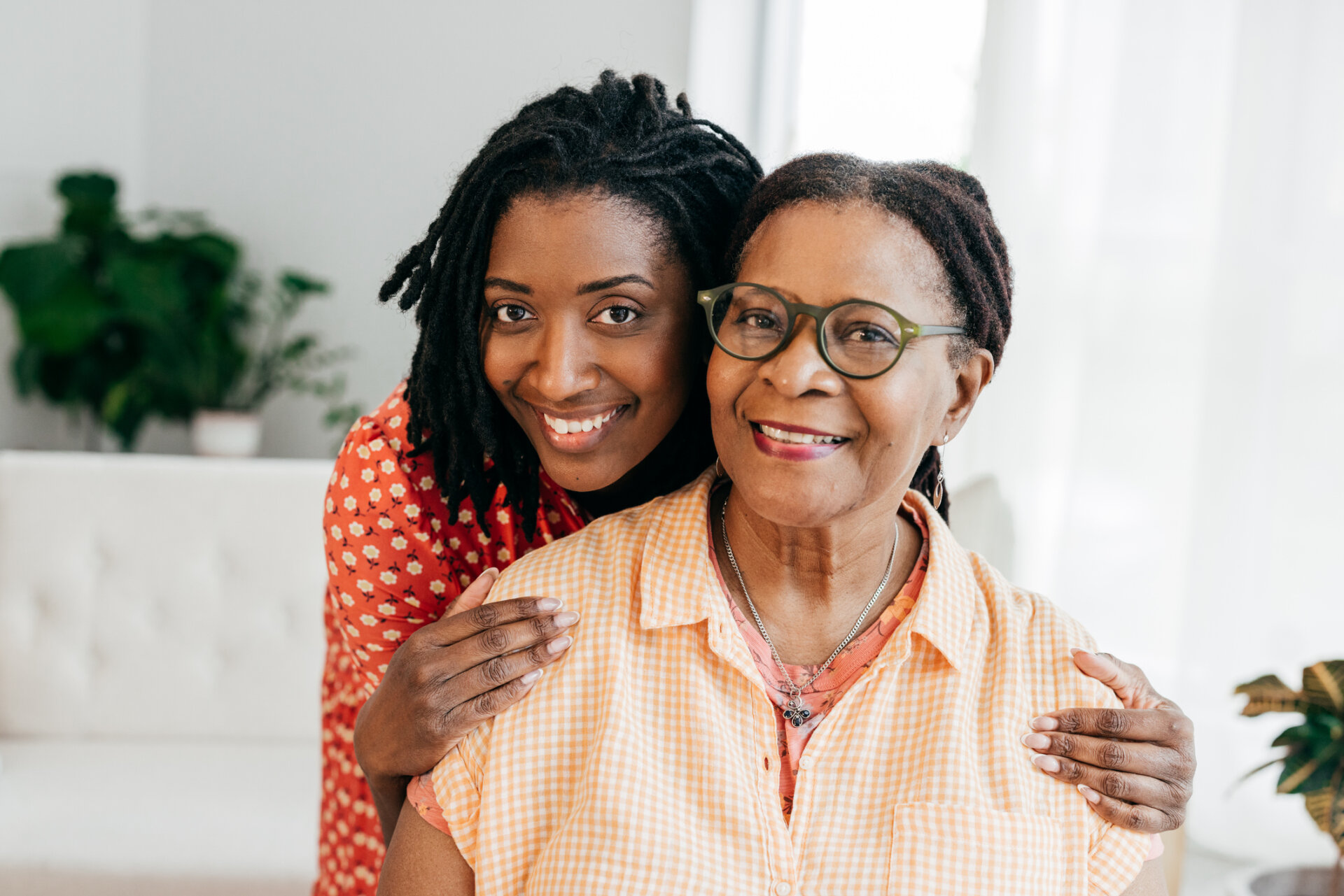 A senior living employee walking with a female resident outdoors